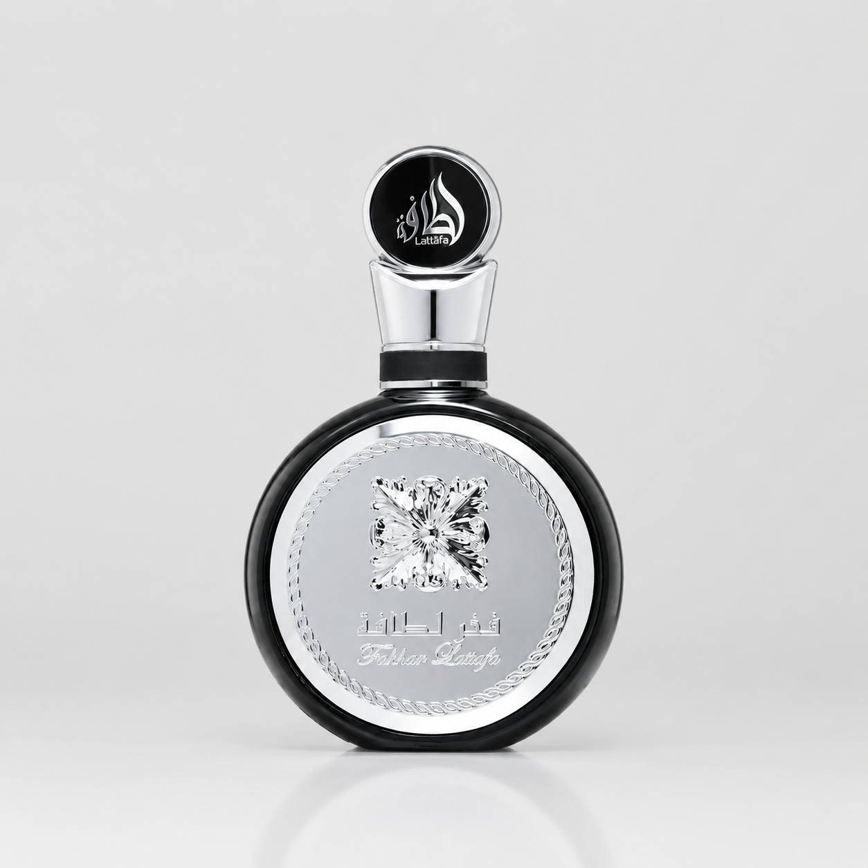 Perfume bottle with black and silver design on a light gray background