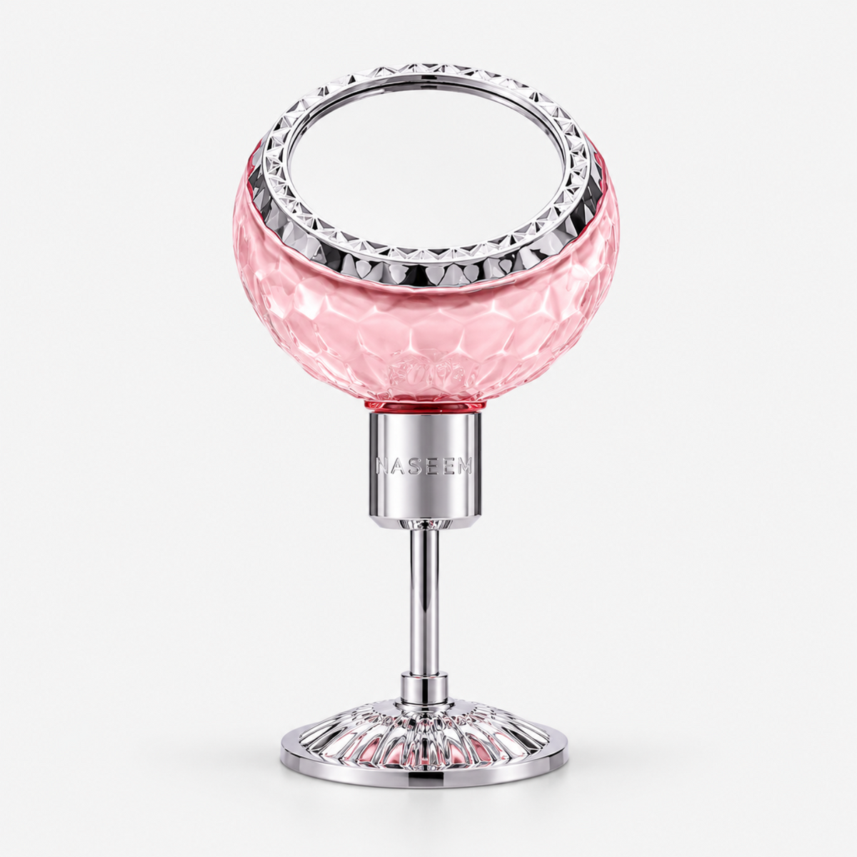A pink faceted glass vanity mirror on a silver metal stand with a round base, shown against a light gray background. The brand name 'MASEEN' is embossed on the silver neck.