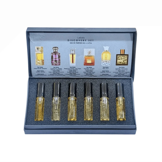 Set of six perfume bottles in a display case with labels on a white background