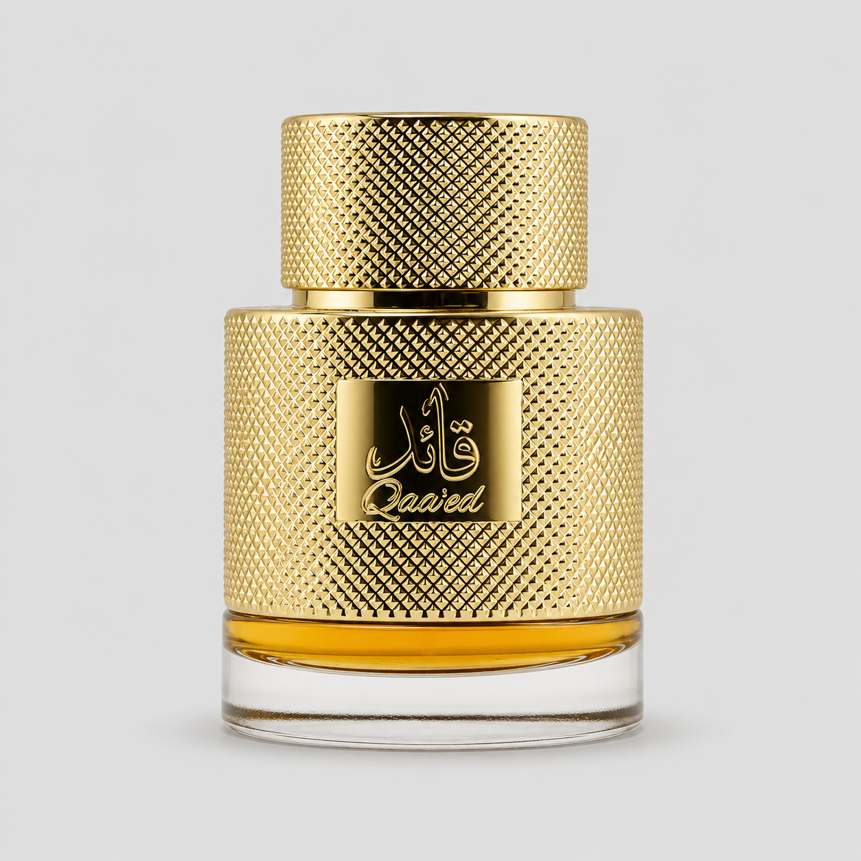 A bottle of Qaaied perfume with a textured gold cap and a matching gold label featuring Arabic calligraphy and the brand name 'Qaaied'. The bottle has a clear glass base showing the golden liquid inside, set against a solid light gray background.
