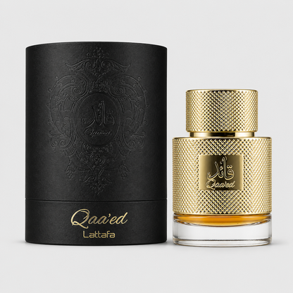 Qa'ed Lattafa perfume bottle with a textured gold cap and gold-embossed body next to its black cylindrical box with gold lettering, on a light gray background.