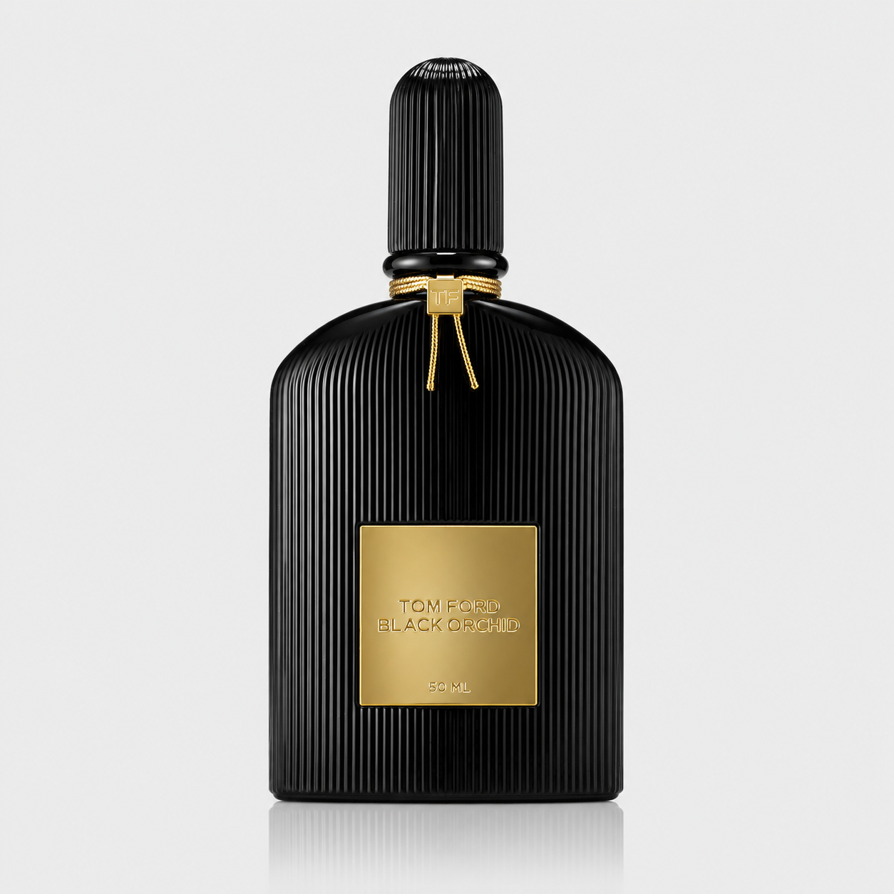 Black perfume bottle with gold label on a light gray background