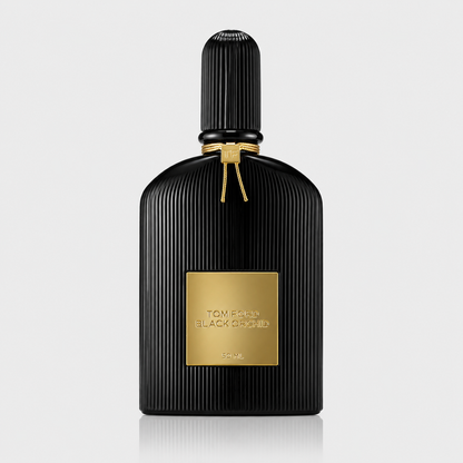 Black perfume bottle with gold label on a light gray background